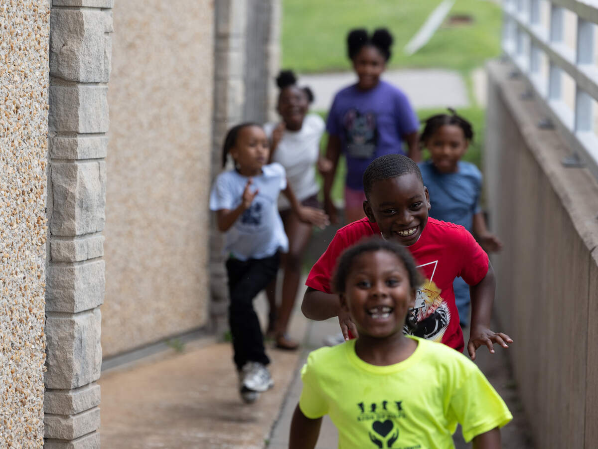 Children at the Kids of Hope Childhood Development Center in East St. Louis run out to grab candy thrown during the 618 Day/Juneteenth parade on June 18.