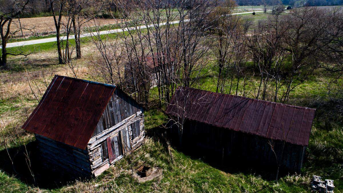 Historic log cabins are displayed on Wednesday, April 12, 2023, at the New Philadelphia National Historic Site in New Philadelphia, Ill.