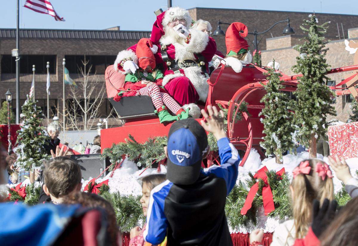 Children wave to Santa as he makes his way down Main Street in Belleville during the Annual Santa Parade. In Highland, Santa will be visiting children via Zoom this holiday season due to the ongoing coronavirus pandemic.