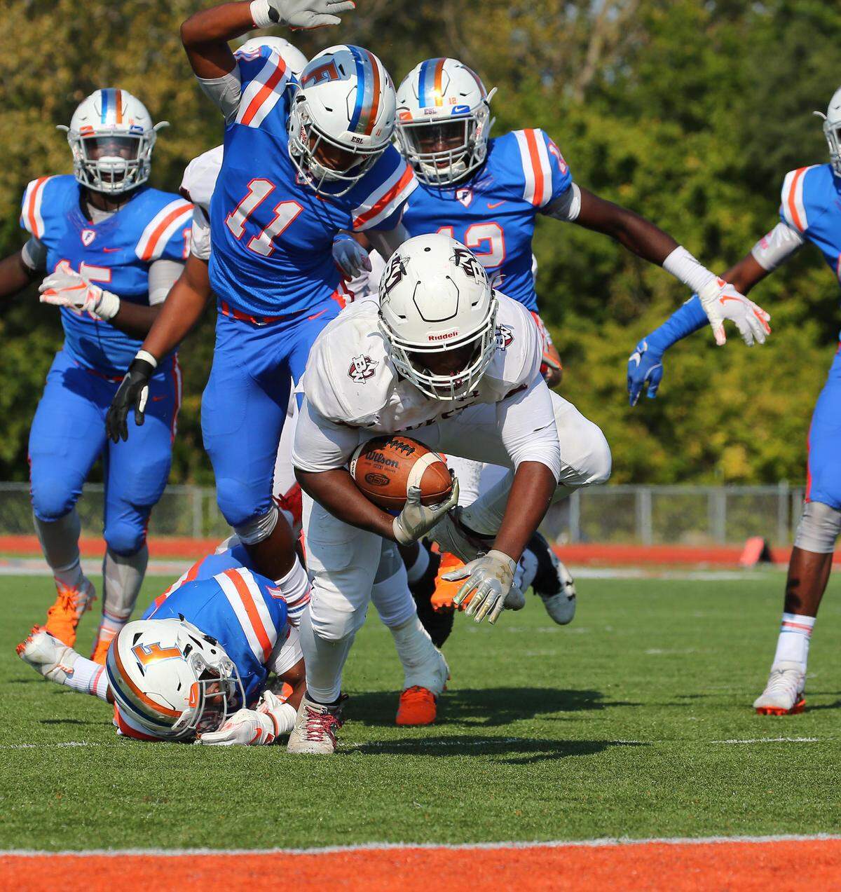 The Maroons’ DJ Johnson carries the ball during Belleville West’s loss at East St. Louis Saturday.