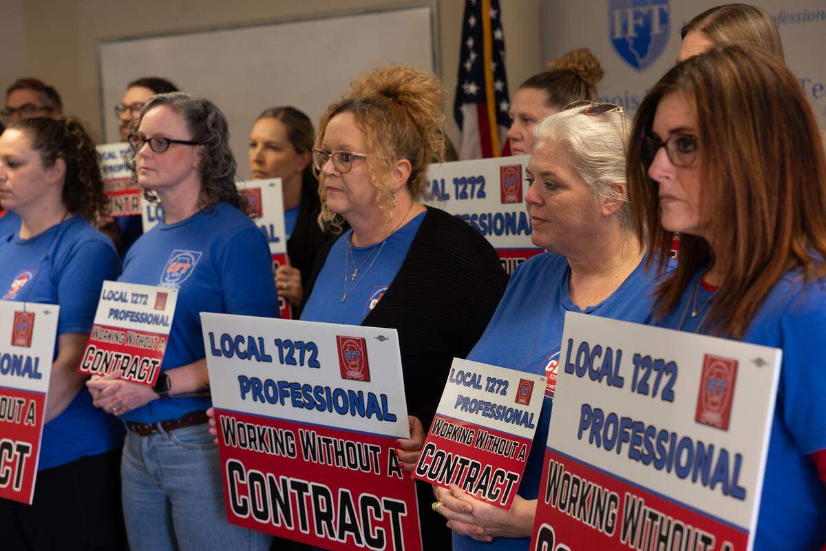Teachers with Cahokia Federation of Teachers Local 1272 hold signs during a March 18 news conference in Fairview Heights regarding the union and their complaints with district leadership.