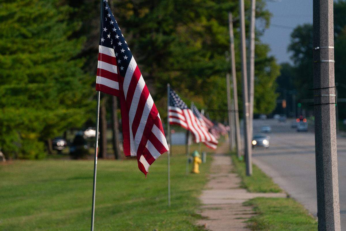 A flag placed along a funeral route as part of a homecoming for a fallen servicemember on Sept. 21, 2023.