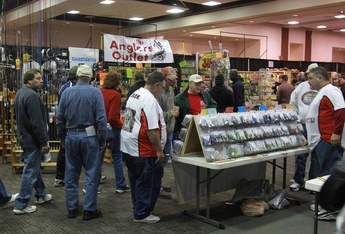 People check out fishing lures and tackle at one of the many displays inside the Gateway Center in Collinsville at a previous “Let’s Go Fishing Show. This year’s show will again include dozens of booths, seminars with fishing experts, displays of fishing tackle and other gear, and displays and sales of fishing boats. The show starts Friday and runs through Sunday.