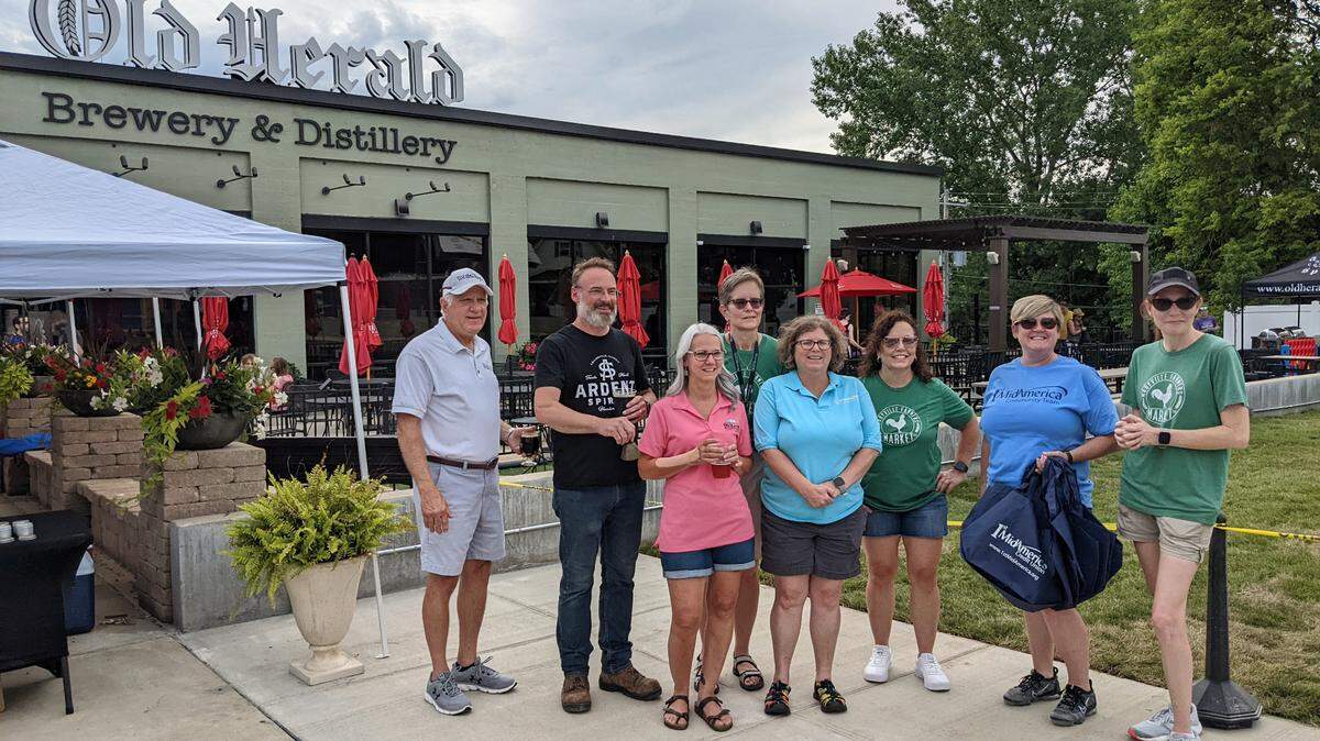 Those present at the inaugural Herald Square Farmers Market included Maryville Farmers Market president and founder Anne Matthews (at far right), Old Herald Brewery owner Derik Reiser (second from left) and Collinsville Mayor John Miller (far left).