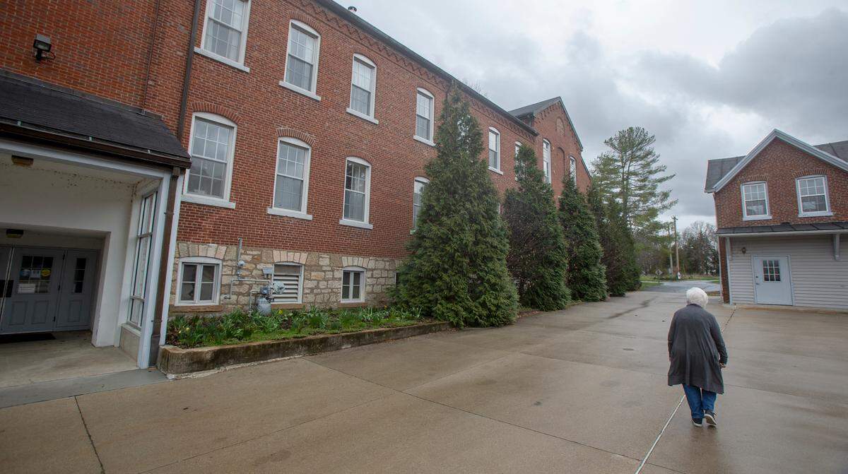 Sister Regina Siegfried gives a tour of the Adorers of the Blood of Christ convent in Ruma, pointing out the original brick structure, at left, built in 1867 to house a Catholic school. It’s sandwiched between newer additions on either side.