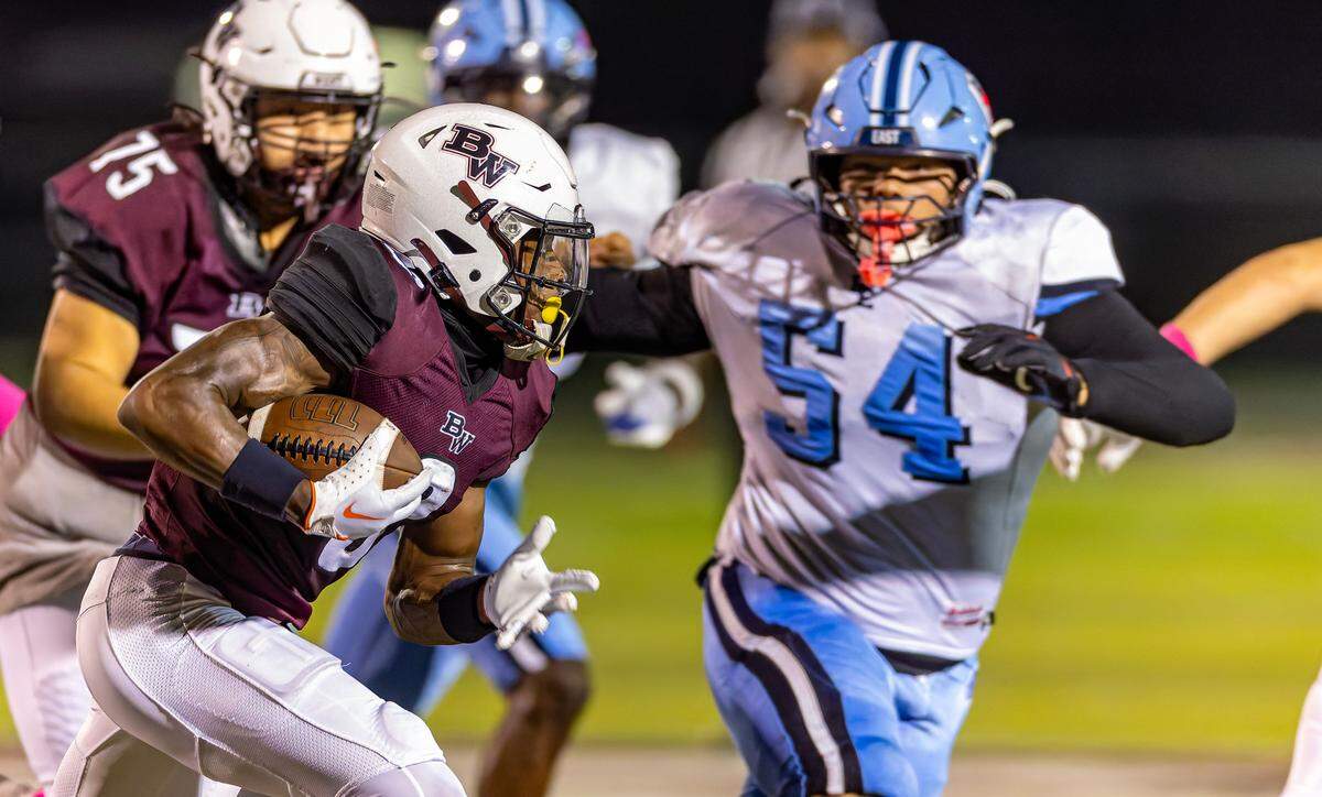 Belleville West’s Nicholas Hankins carries against East at Goalby Field Friday.