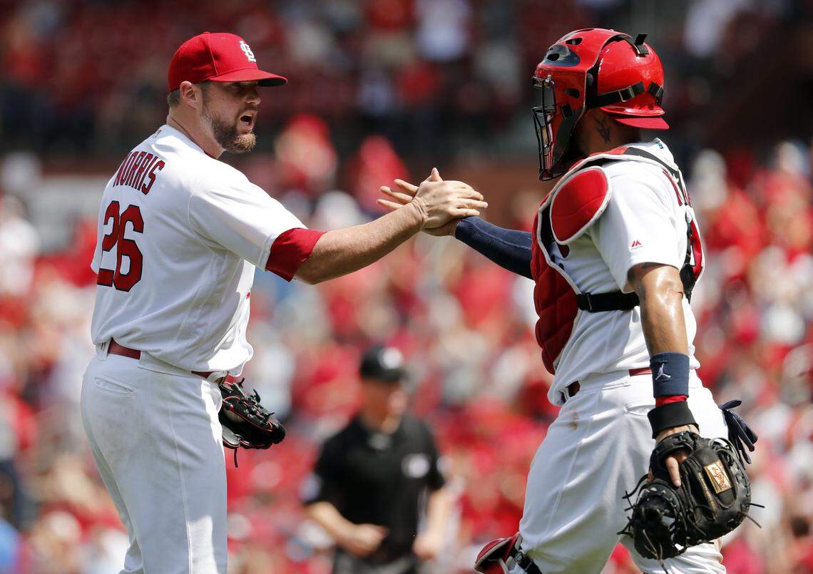 St. Louis Cardinals relief pitcher Bud Norris, left, and catcher Yadier Molina celebrate following a baseball game against the Chicago White Sox, Wednesday. The Cardinals won 3-2.