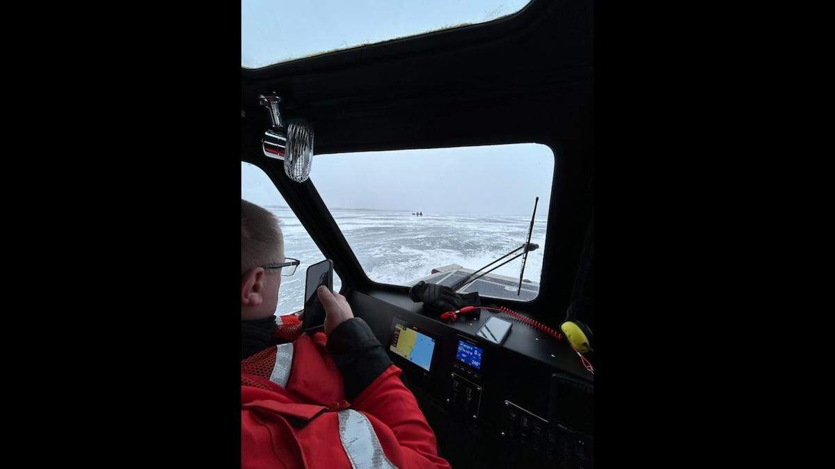 U.S. Coast Guard rescuers used a boat to rescue stranded ice fishers.