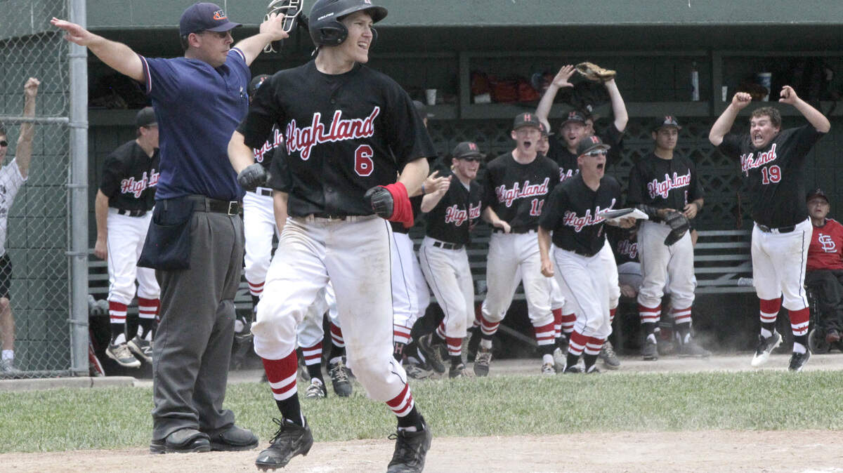 Highland's dugout cheers as Jonathan Dickman scores the go-ahead run in the top of the sixth inning of the Bulldogs' regional final game with Columbia.