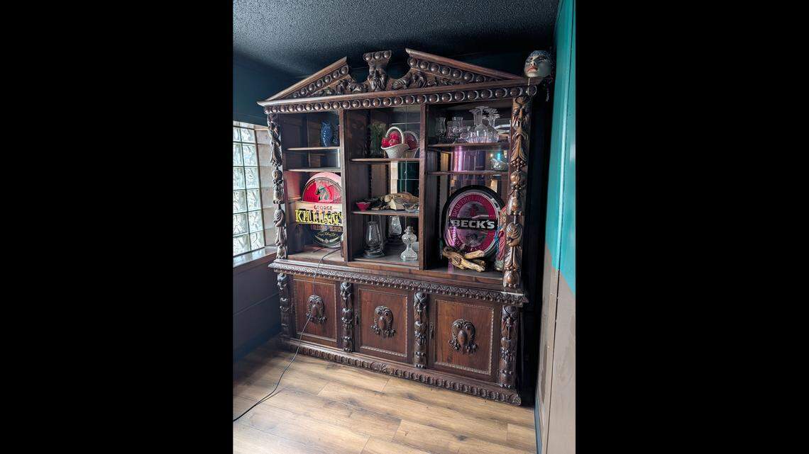 This wood cabinet was included with the property when Patel bought it. It took six people to move it across the room.