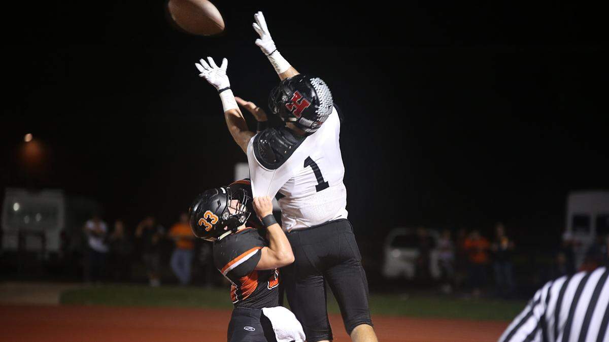 Highland senior Sam LaPorta goes high over Waterloo defender Dalton Viglasky during the Mississippi Valey Conference battle of Bulldogs Friday.