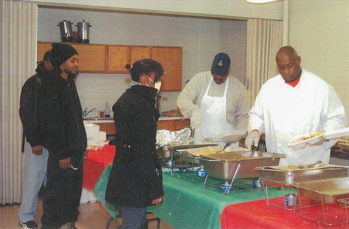 Kevin Anderson, far right, serves hot meals to people in the East St. Louis community on Thanksgiving Day in 2015. He also does it on Christmas Day.