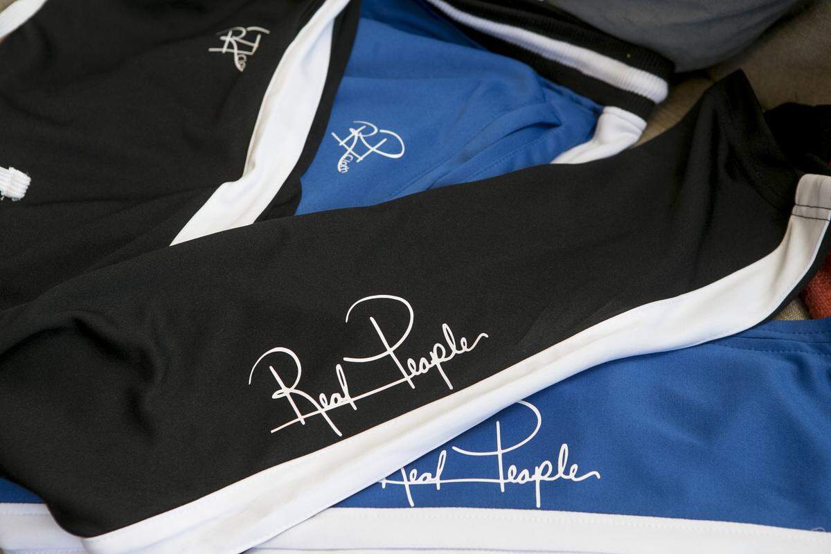 Track pants with fashion designer Duke Liddell’s logo “Real People.”