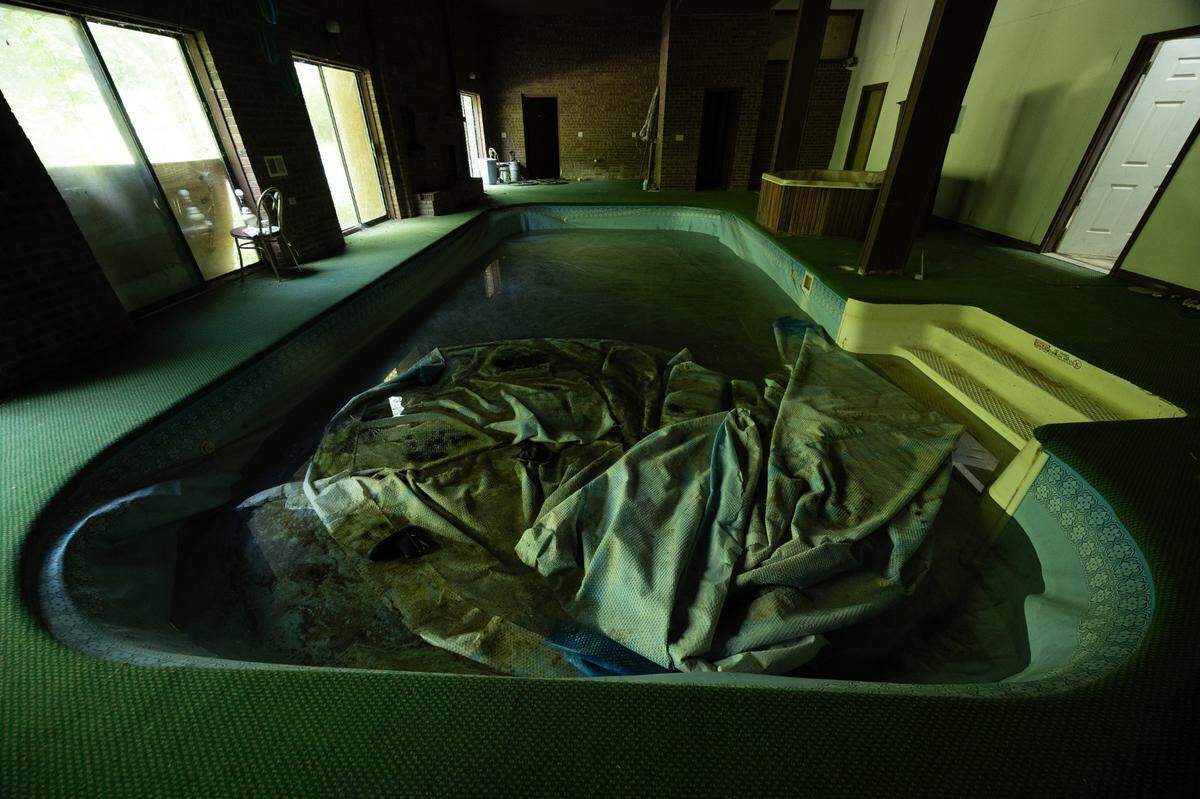 Though it is currently inundated with mold, the swimming pool in the basement adds a unique feature to the home.