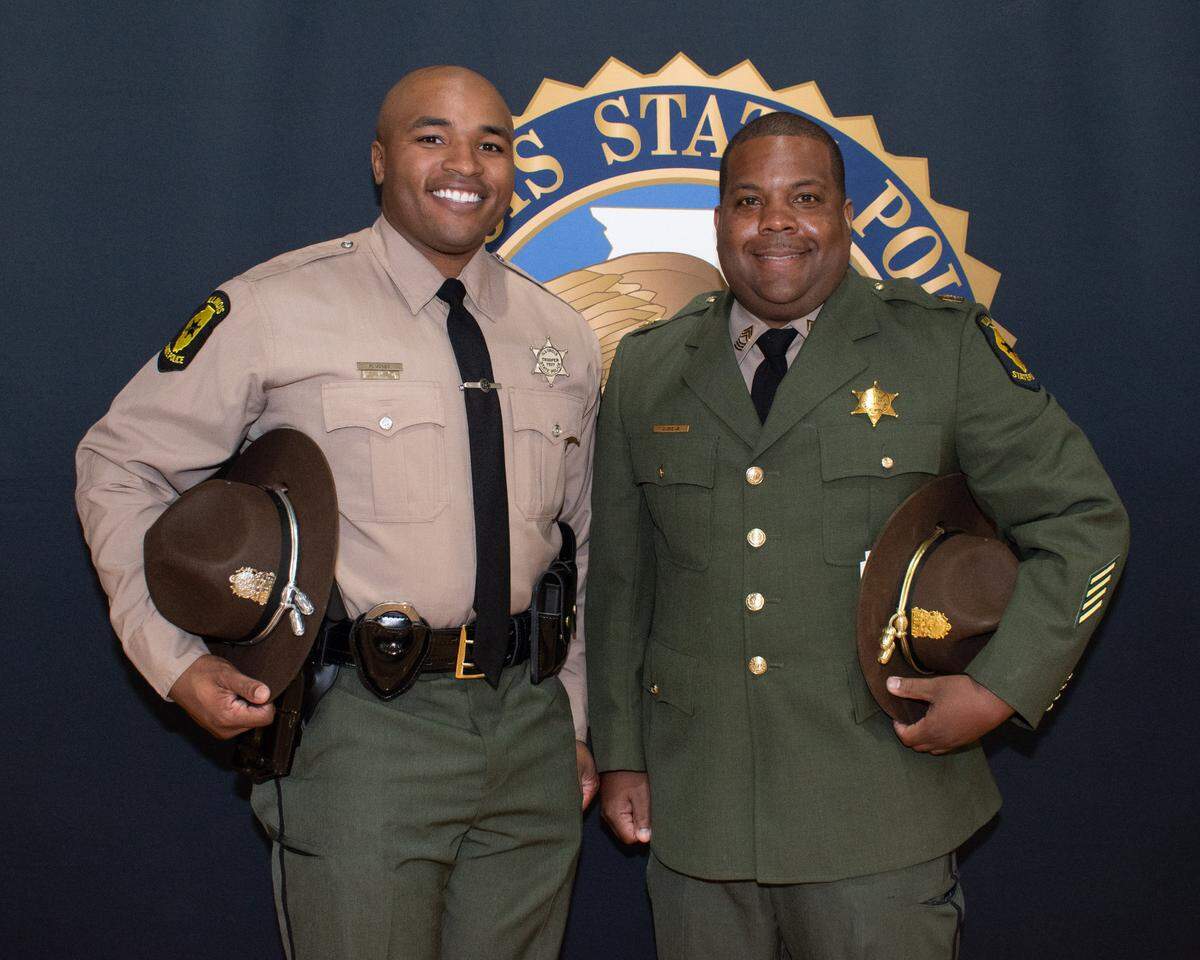 Illinois State Police Trooper Marquis Jones and ISP Master Sgt. Calvin Dye Jr. celebrate Jones officially becoming a state police trooper at the Springfield graduation. Jones attended the Metro-East Team Illinois Youth Police Camp three times as a teenager. “The youth camp helped put me on the path of wanting to achieve my goals and kept me in a straight line,” Jones says.