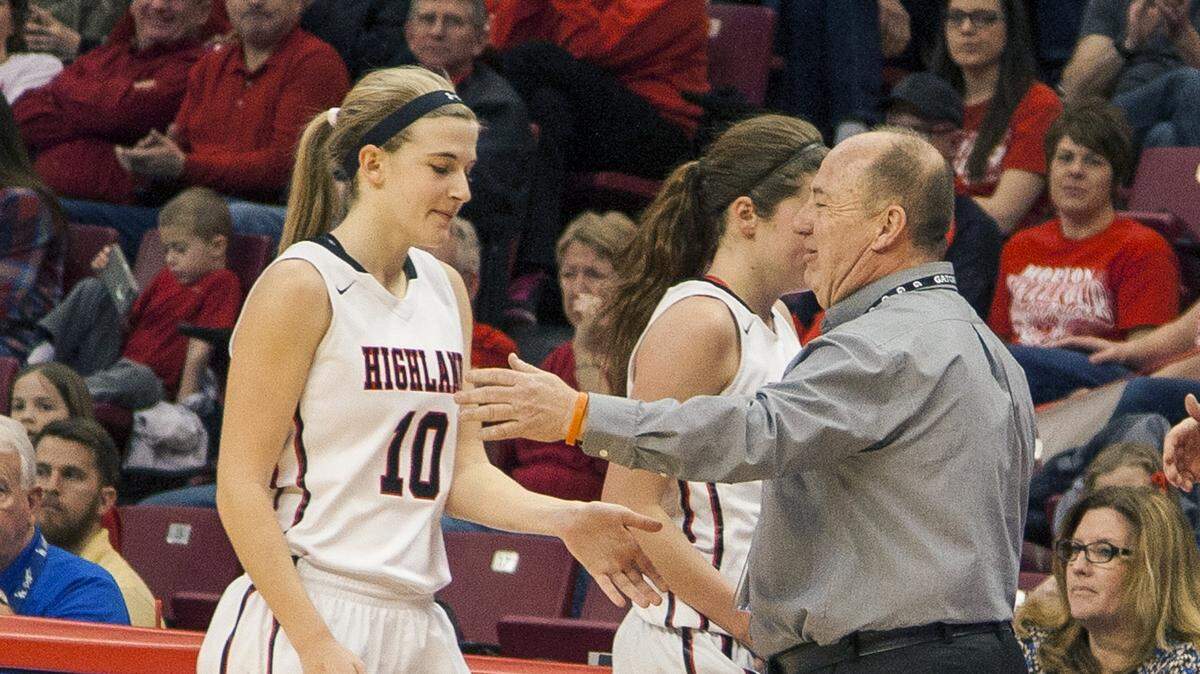 Former Highland girls basketball coach Mike Arbuthnot congratulates Caitlan Lammers (10) and Amanda Ponce near the end of Highland’s 62-51 victory over Chicago Morgan Park in the IHSA Class 3A third place game at Redbird Arena on the campus of Illinois State University in Bloomington-Normal in March 2016. The IHSA has announced the girls basketball state finals will remain at Redbird Arena for the next three seasons.