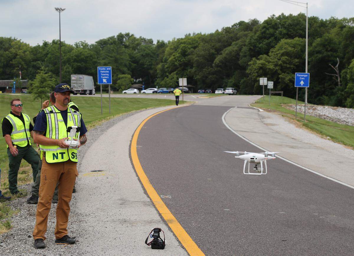 In this July 13, 2023 photo, National Transportation Safety Board investigator Eric Gregson launches a drone to document the roadway and surrounding area at the site of the July 12 crash on I-70 near Highland, Illinois.