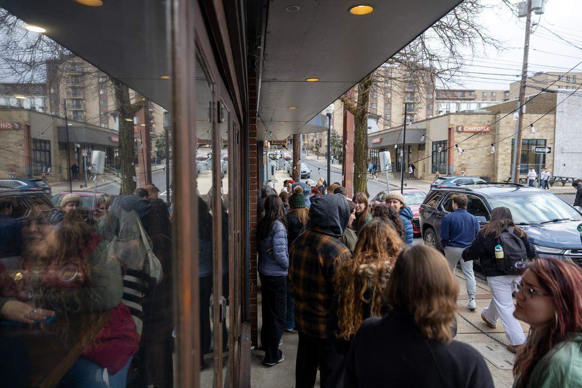 The line to enter The Press Cider and Craft Beverage Tap House and take photos with Punxsutawney Phil is seen wrapping around the opposite end of the block on Saturday, Jan. 17, 2026 in State College.