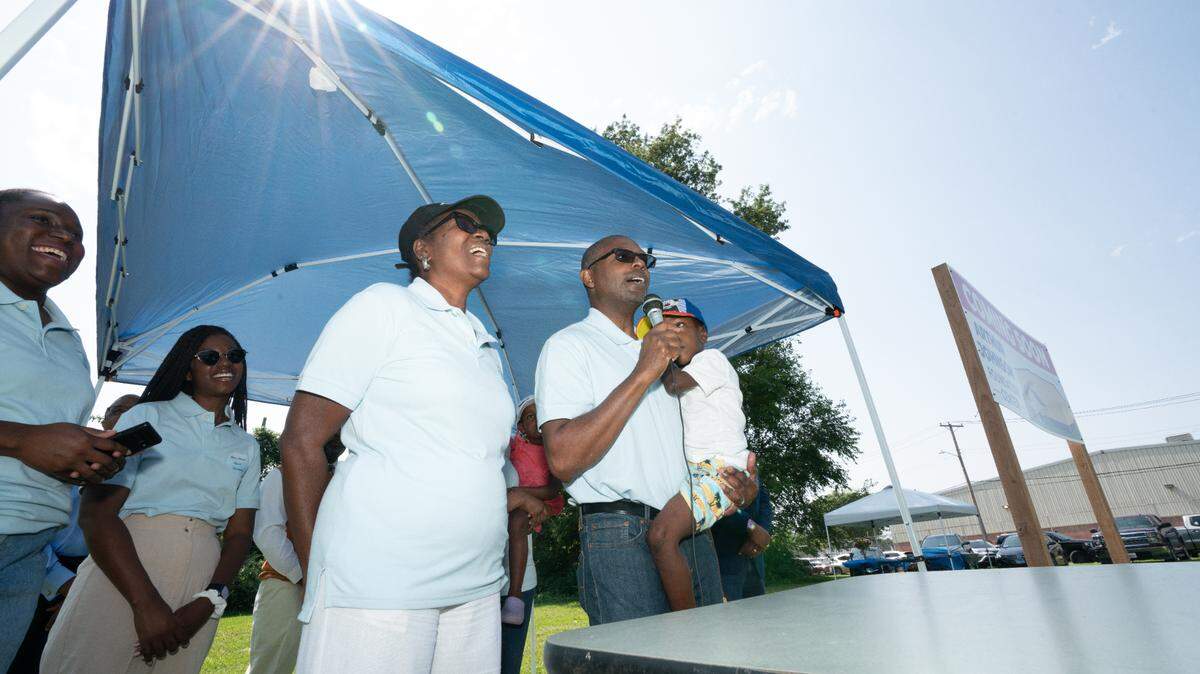 Boxing champion Arthur “Flash” Johnson leads the crowd in a hymn at a groundbreaking ceremony of his foundation’s new gym in East St. Louis Saturday. The Arthur Johnson Foundation seeks to empower youth by providing them with the discipline, comradely and mentorship offered by the sport of boxing.