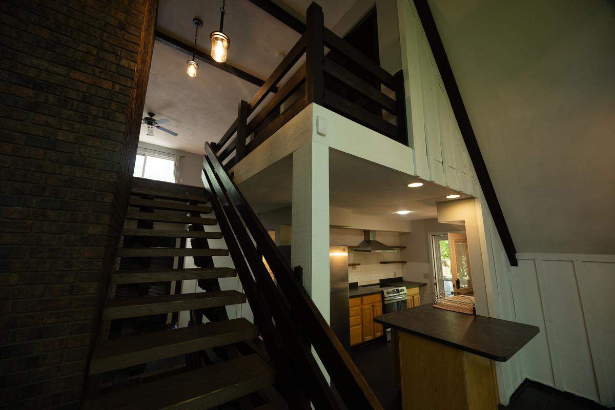 The home boasts a unique blend of classic and contemporary touches, where modern appliances and sleek wooden floors blend well with exposed brick and wooden beams.