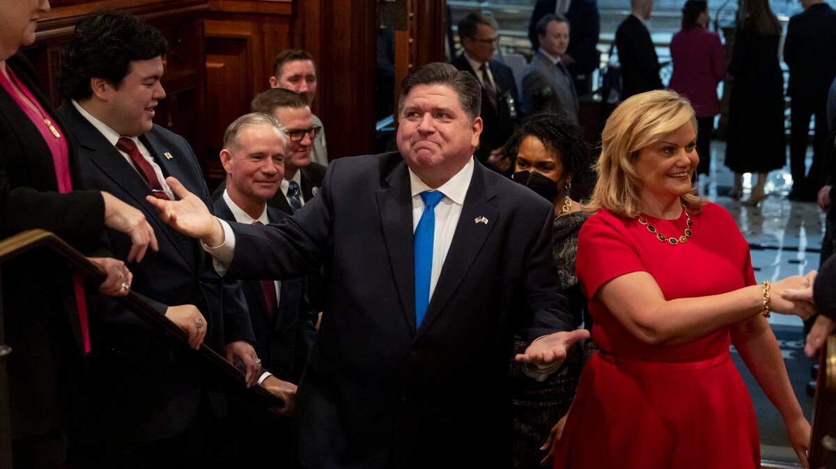 Gov. J.B. Pritzker arrives with first lady M.K. Pritzker to deliver his his combined budget and State of the State address to a joint session of the General Assembly on Wednesday, Feb. 15, 2023 at the Illinois State Capitol in Springfield, Ill. (Brian Cassella/Chicago Tribune via AP, Pool)