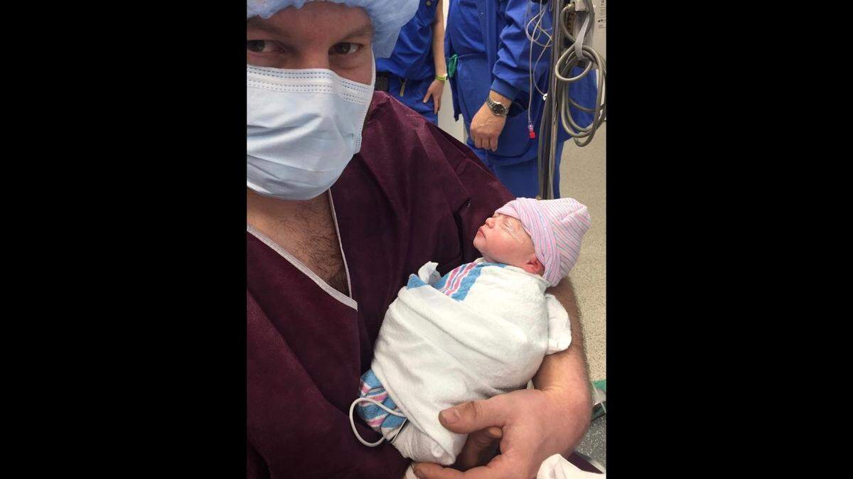 Alex Stroh, 32, of rural O’Fallon, holds his newborn daughter, Delaney, who was born six weeks premature on March 7. She’s now at home and doing fine.