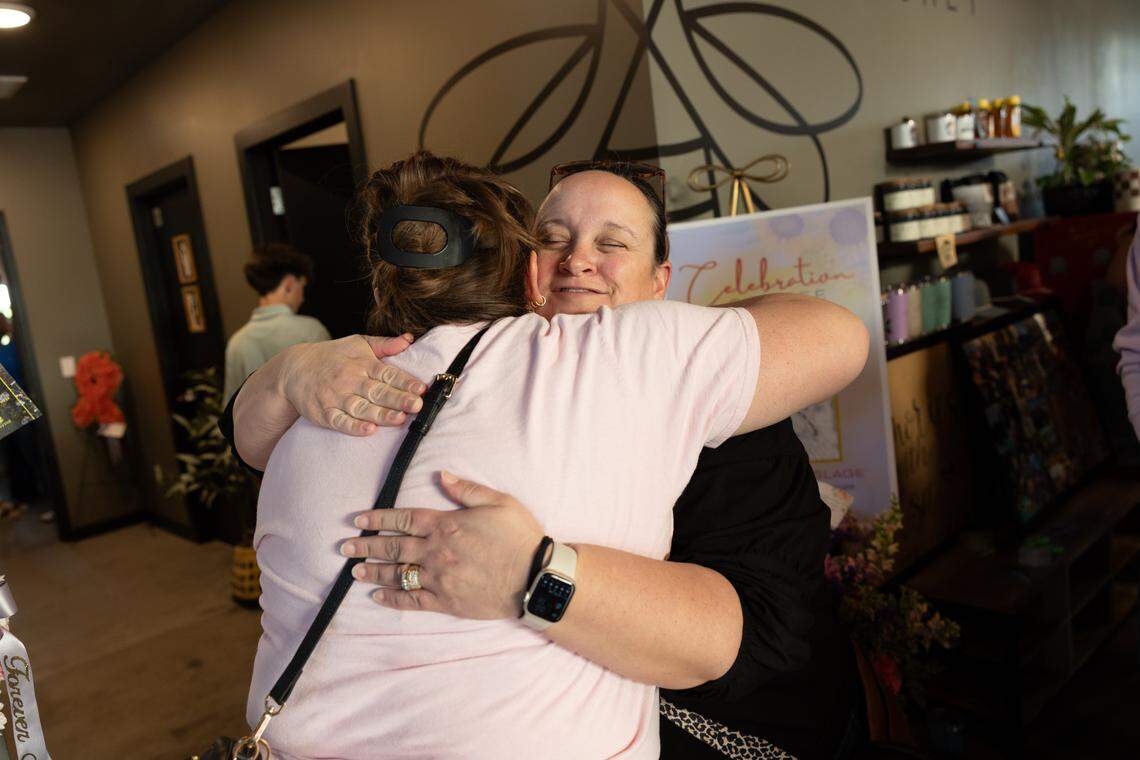 A loved one Adrienne Wiemerslage hugs her during a celebration of life of her daughter Elsie, who died on April 15 after a decade-long battle with childhood cancer.