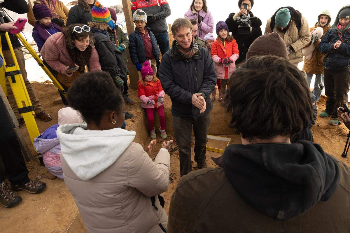 Professor Andrew Martin (center) celebrates with his students Natasha Kemirembe (L) and Ernesto Botero after successfully unearthing a mastodon tooth at Principia College on Dec. 5, 2024. Martin says the project took two years.