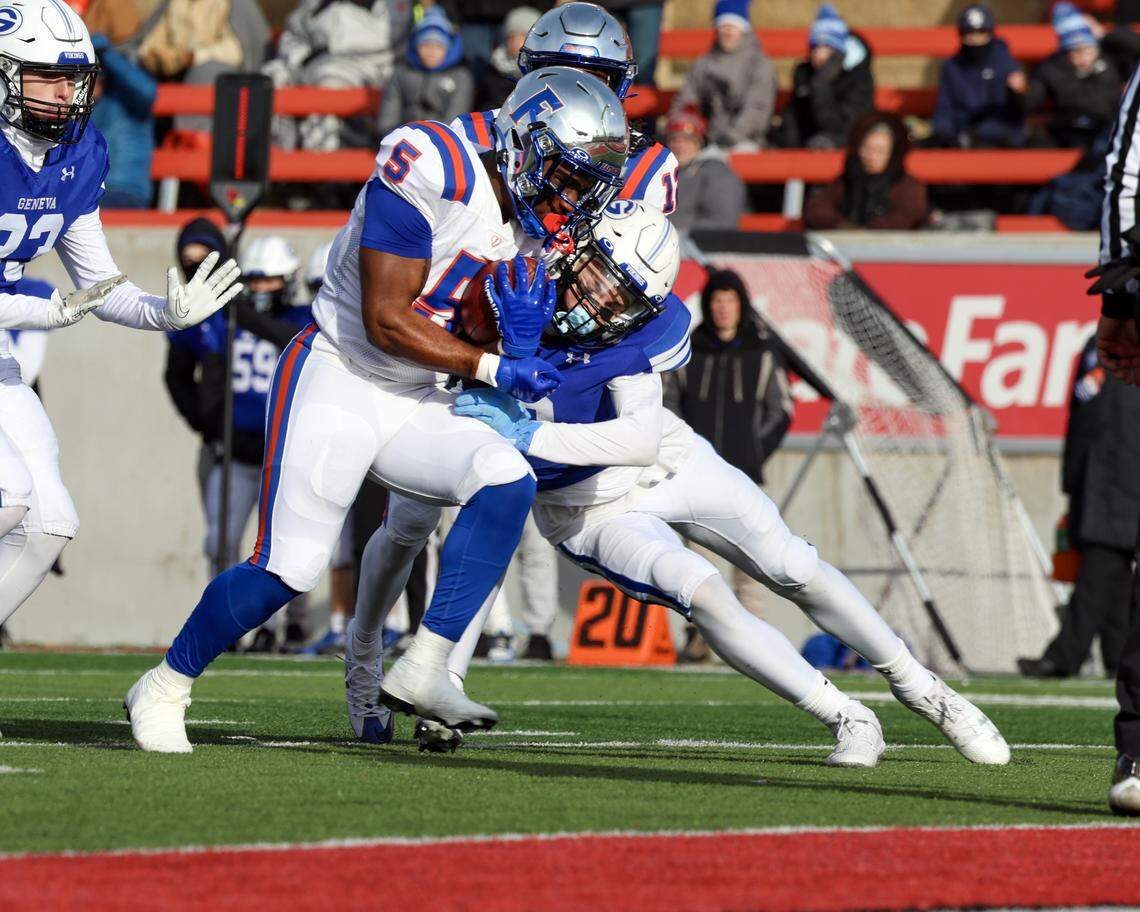 East St. Louis’ Larevious Woods drives his way into the endzone for one of his three touchdowns during the Illinois Class 6A championship game against Geneva at Hancock Stadium on the campus of the Illinois State University.