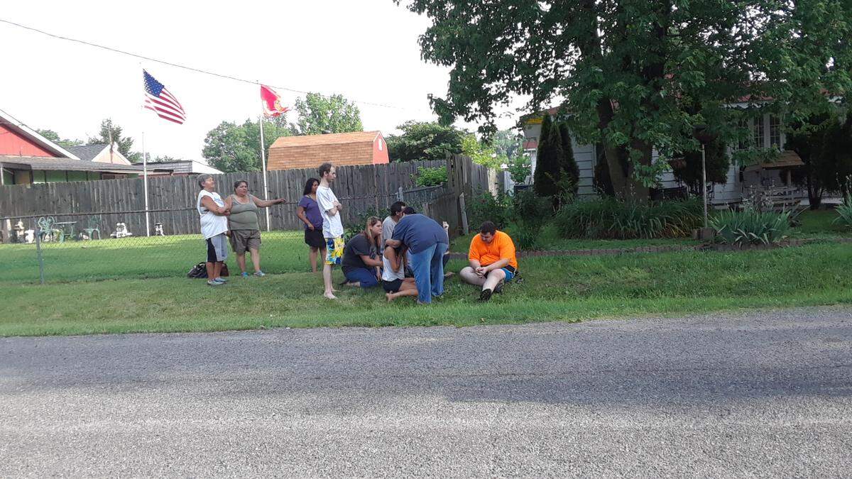 Friends and family gather outside Friday morning as crews respond to a house fire in the 9000 block of Rene Avenue in Collinsville.