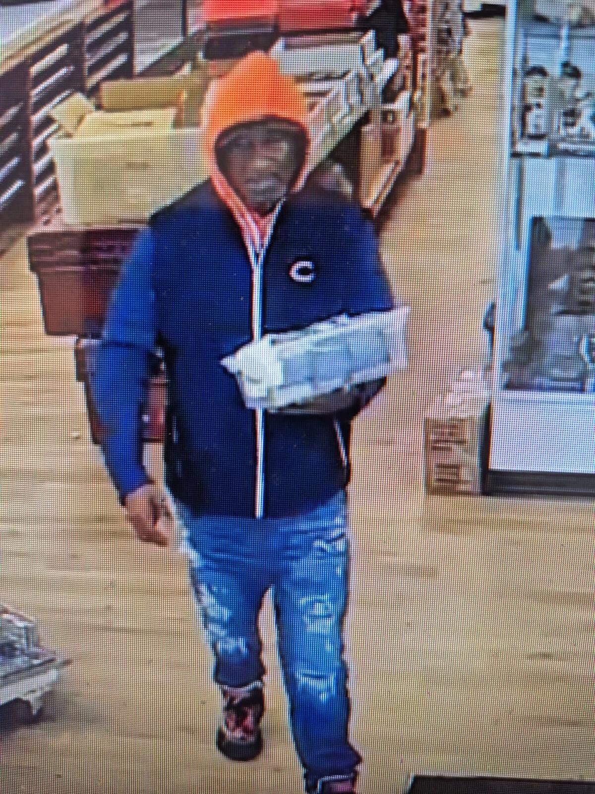 This screenshot from surveillance video shows the suspect in the theft of a $9,000 Jackie Robinson baseball card from a Belleville collector’s store.