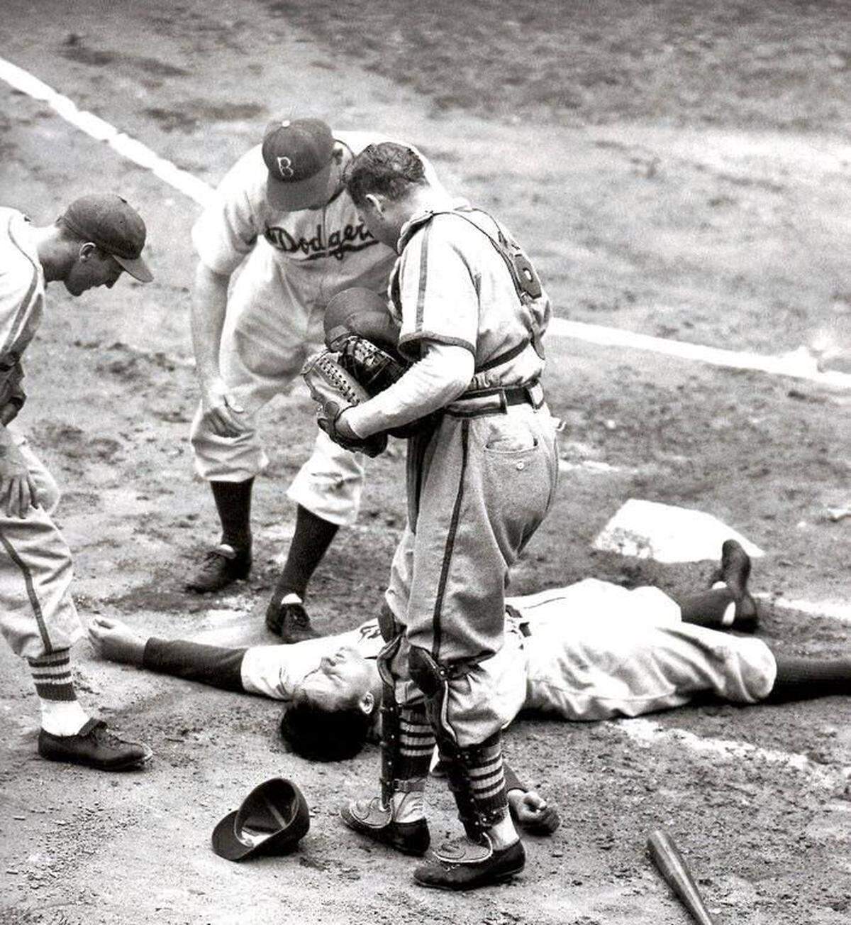 Joe Medwick, then with the Brooklyn Dodgers, lies unconscious in the batter's box of Ebbets Field after being struck in the head by a pitch from the Cardinals Bob Bowman. Medwick had been traded by St. Louis just six days earlier.