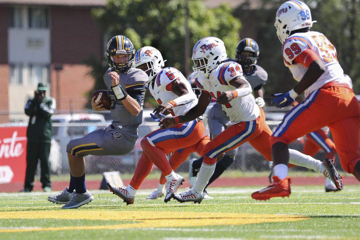 O’Fallon quarterback Colt Michael is sacked by East St. Louis during a Southwestern Conference game this season. Both the Panthers and Flyers are set to open the postseason this weekend.