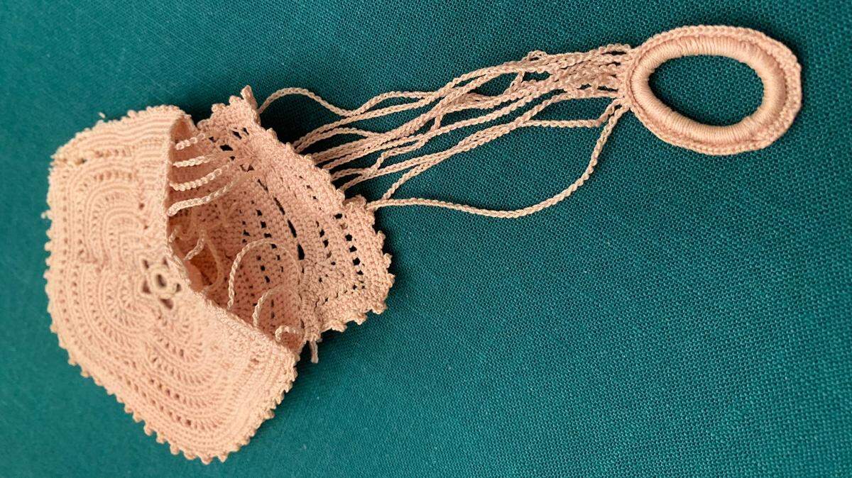 This is a “Victorian String Finger Ring Purse” and dates back to the 1880’s.