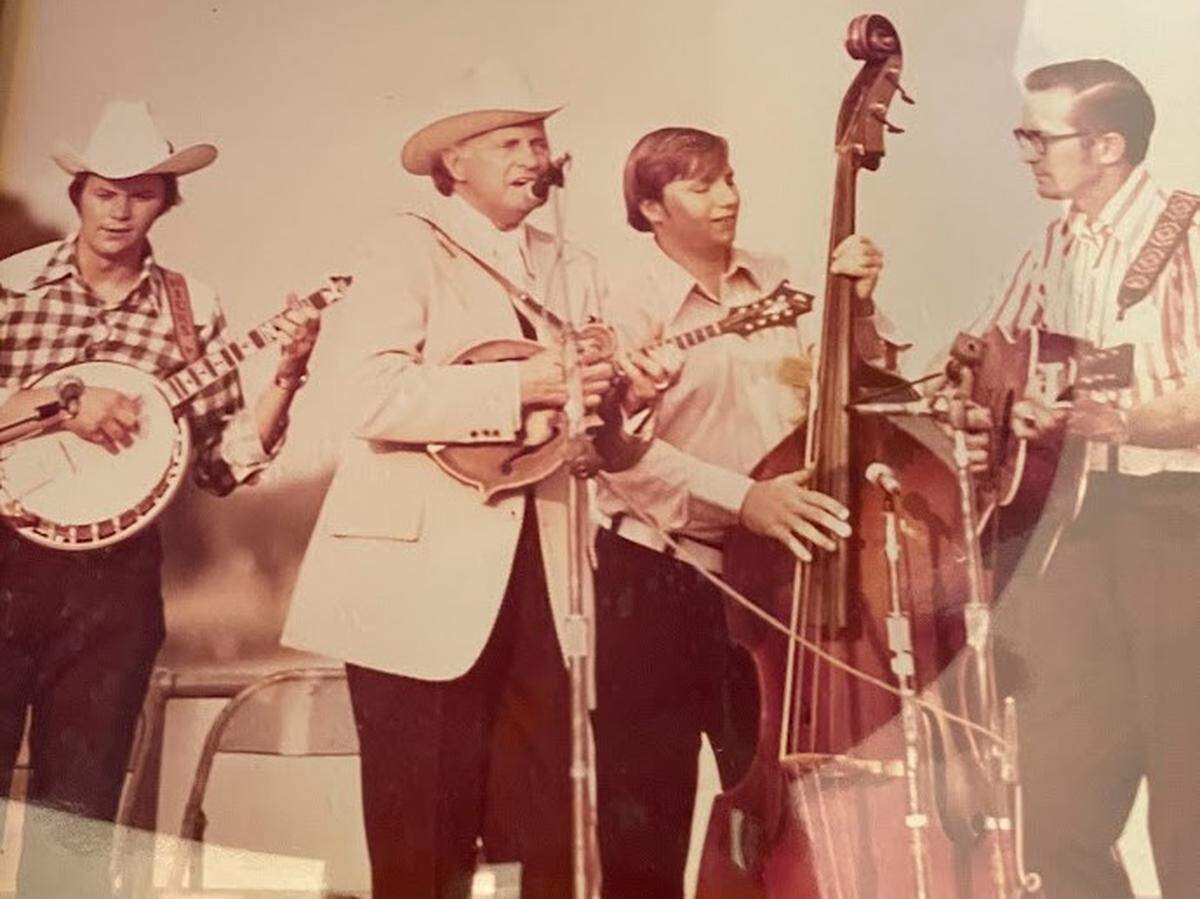 George Portz, second from right, is shown playing bass with the legendary “father of bluegrass” Bill Monroe, second from left, in the 1970s at the Washington Monument in Washington, D.C.