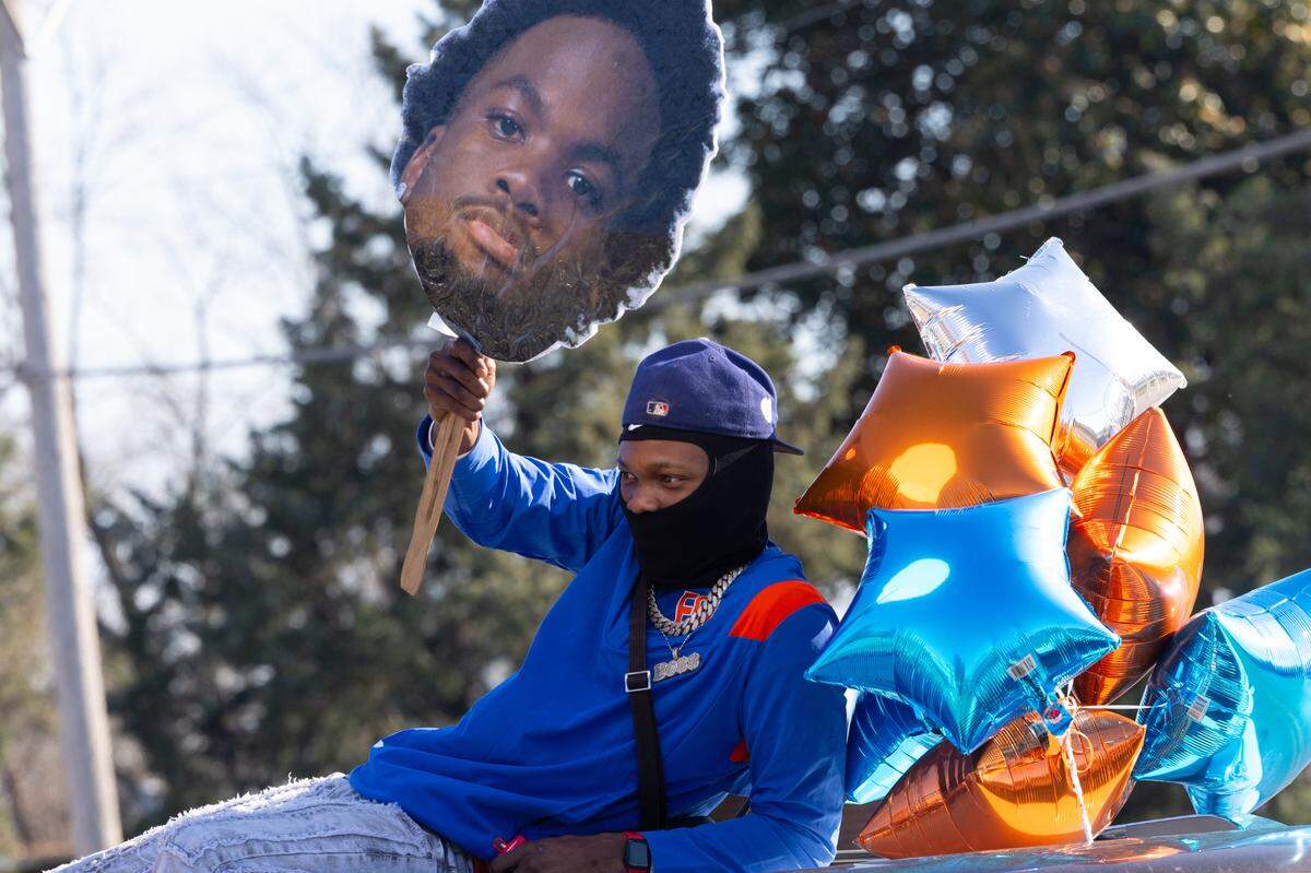 Many fans printed out larger-than-life cutouts of their favorite players for the East St. Louis victory parade on Dec. 4, 2024.