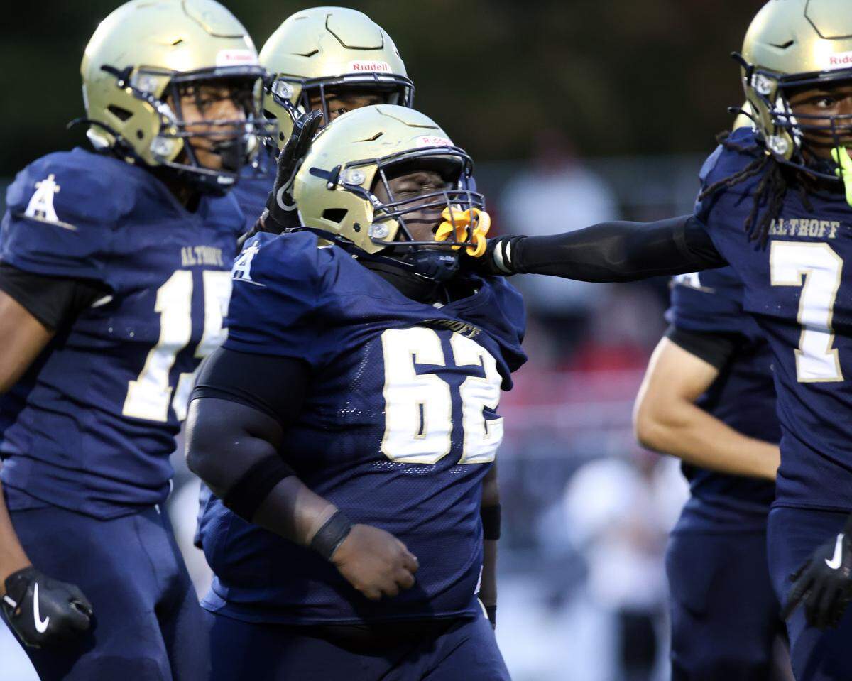 Althoff's Drew McGee celebrates after his pass interception to set up a touchdown.