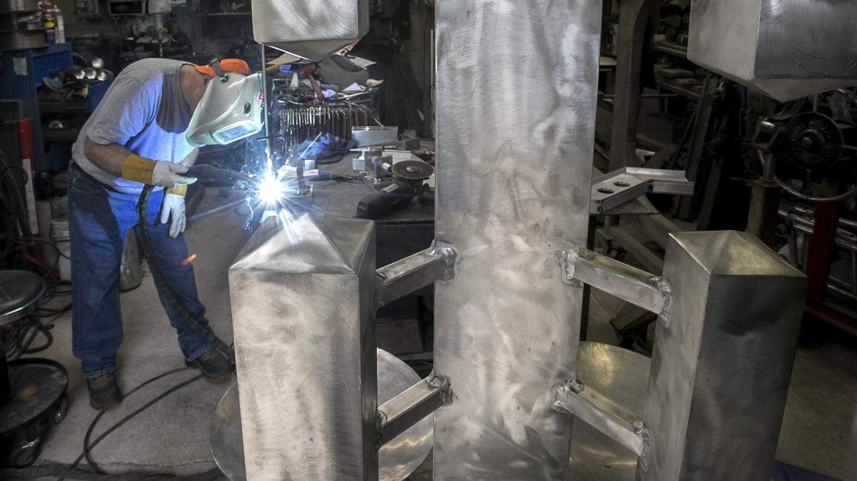 O’Fallon metal sculptor Kevin Trobaugh welds on a base for a new sculpture that incorporates stained glass into an aluminum structure for Midwest Salute to the Arts, taking place this weekend at Moody Park in Fairview Heights. Trobaugh recently designed a large sculpture that was installed at the GRAMMY Museum Mississippi in Cleveland, Mississippi.  