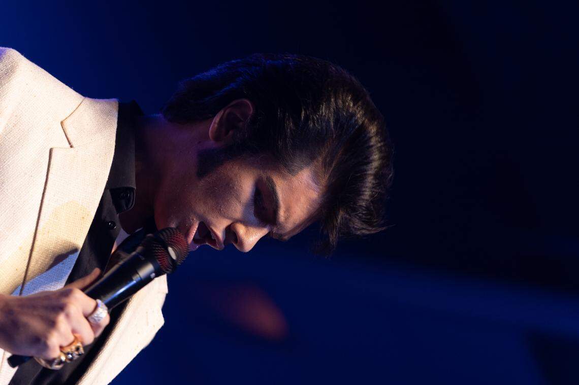 Finley Watkins, who plays 8 instruments and has performed as Elvis since he was young, performs 70s Elvis hits to a crowded Collinsville convention center.