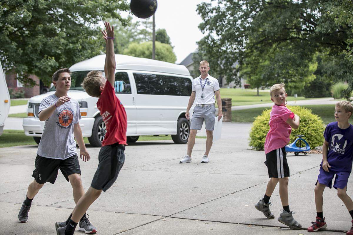 In this 2019 file photo, Mascoutah High School Athletic Director Scott Battas watches basketball players as part of a community program to encourage kids to spend more time outside in the summer.