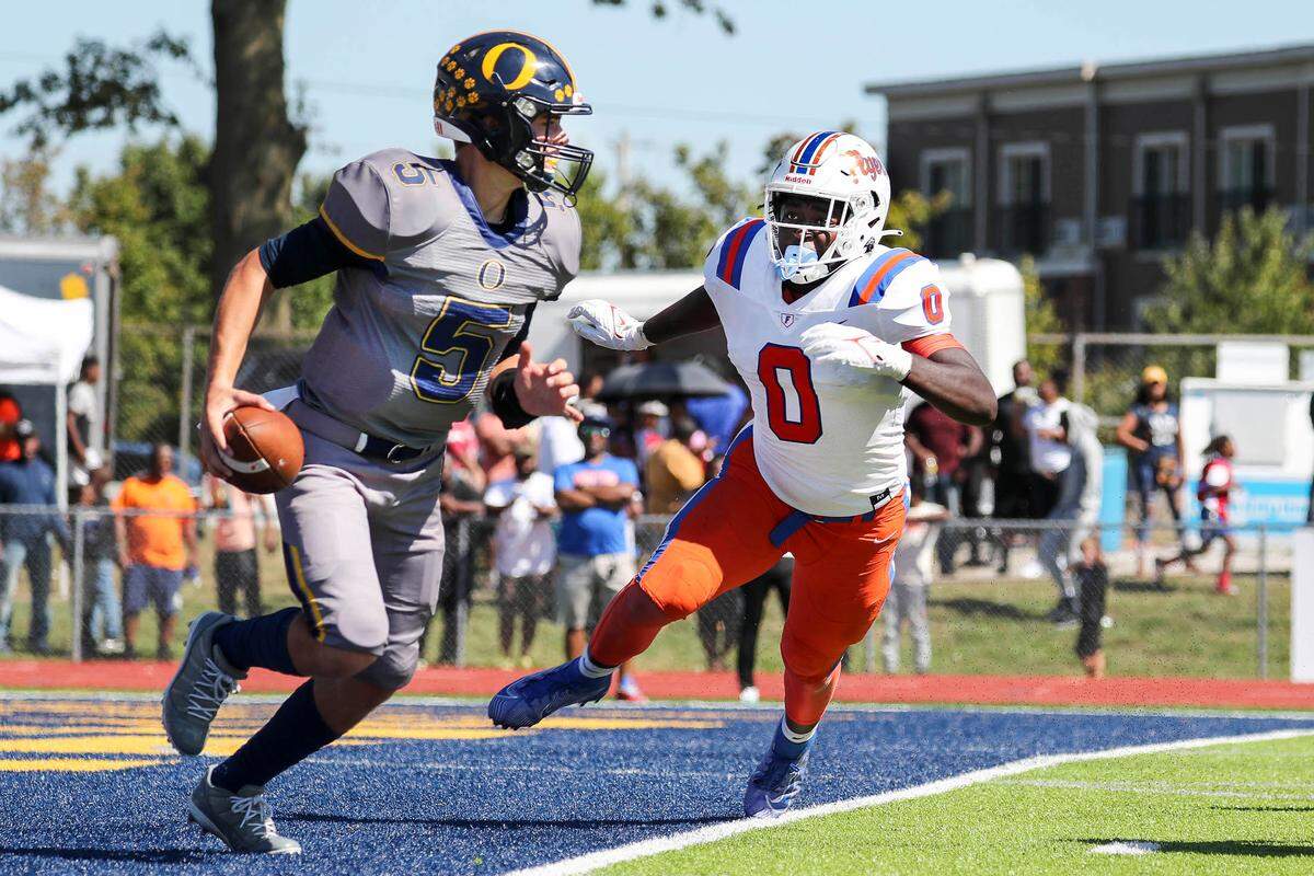 East St. Louis’ Roger MaCary pressures O’Fallon quarterback Colt Michael during Saturday’s Southwestern Conference game. The Flyers posted a 60-21 victory.