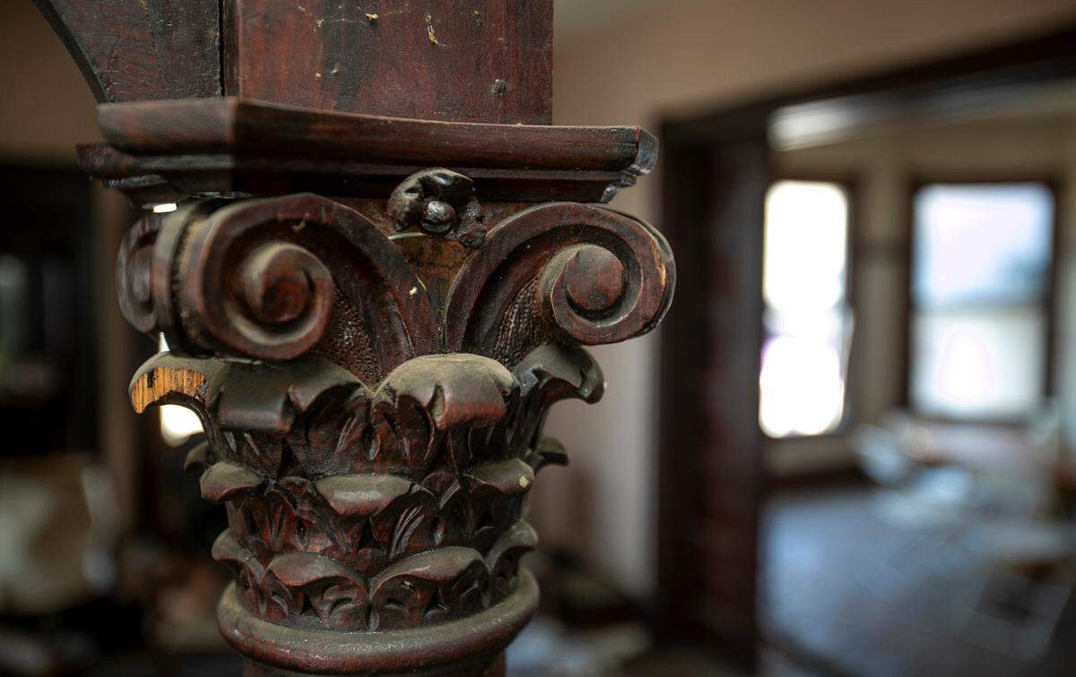 “The Pink House” in Aviston is full of 10-foot-high ceilings, pine floors and unpainted woodwork, including this ornate carving on a column between the foyer and parlor on the first floor.