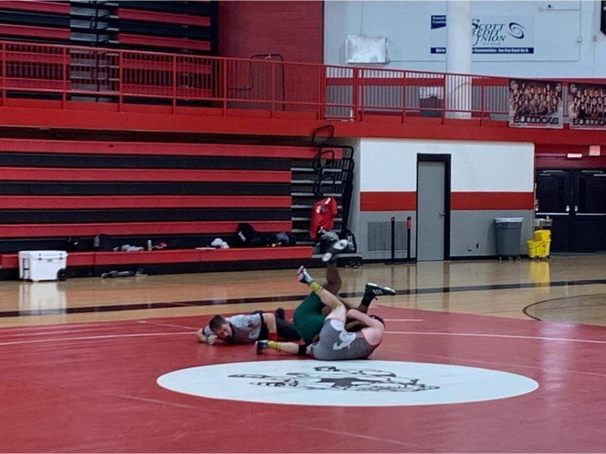 Highland senior Benny Mitchell pins his opponent from Metro-East Lutheran in the first period of his match at 170 pounds Monday, Jan. 24, on Senior Night at Highland High School. Mitchell concluded his home career at HHS with a strong performance against the Knights.