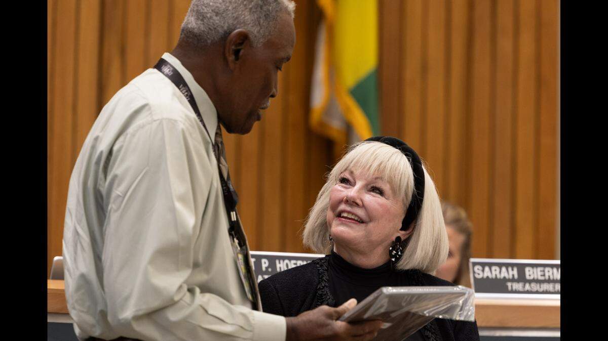 Ward 4 Alderman Johnnie Anthony presents a plaque to Belleville Mayor Patty Gregory at her last City Council meeting on Monday night after praising her “fantastic” accomplishments.