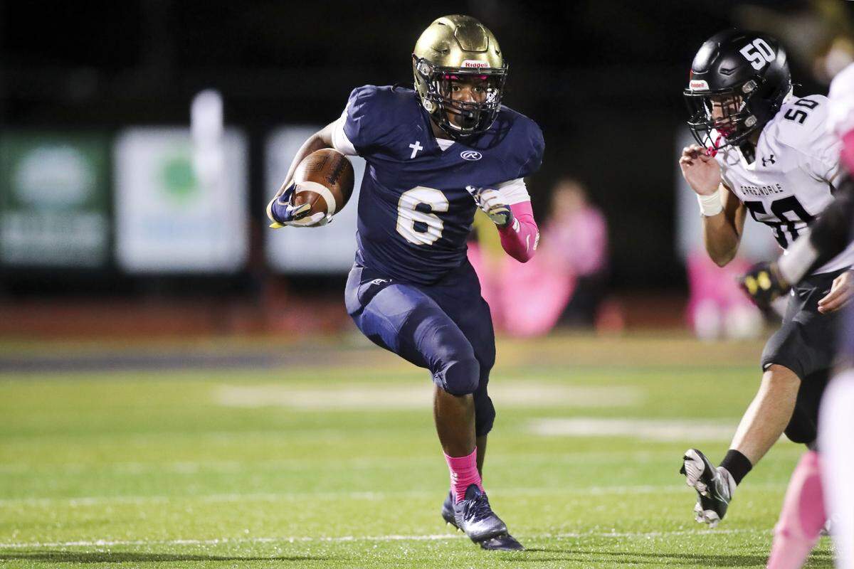 Althoff’s Lucious Dones carries the ball during Friday night’s South Seven Conference matchup against Carbondale. The Crusaders ultimately lost 10-7.