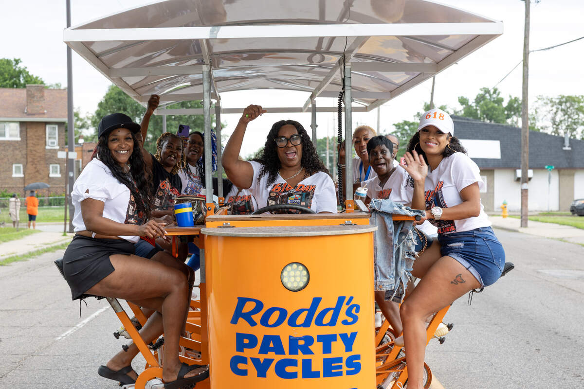 Local residents ride a party cycle, a large contraption where everyone involved pedals to move forward, during a 618 Day/Juneteenth parade in East St. Louis on June 18.