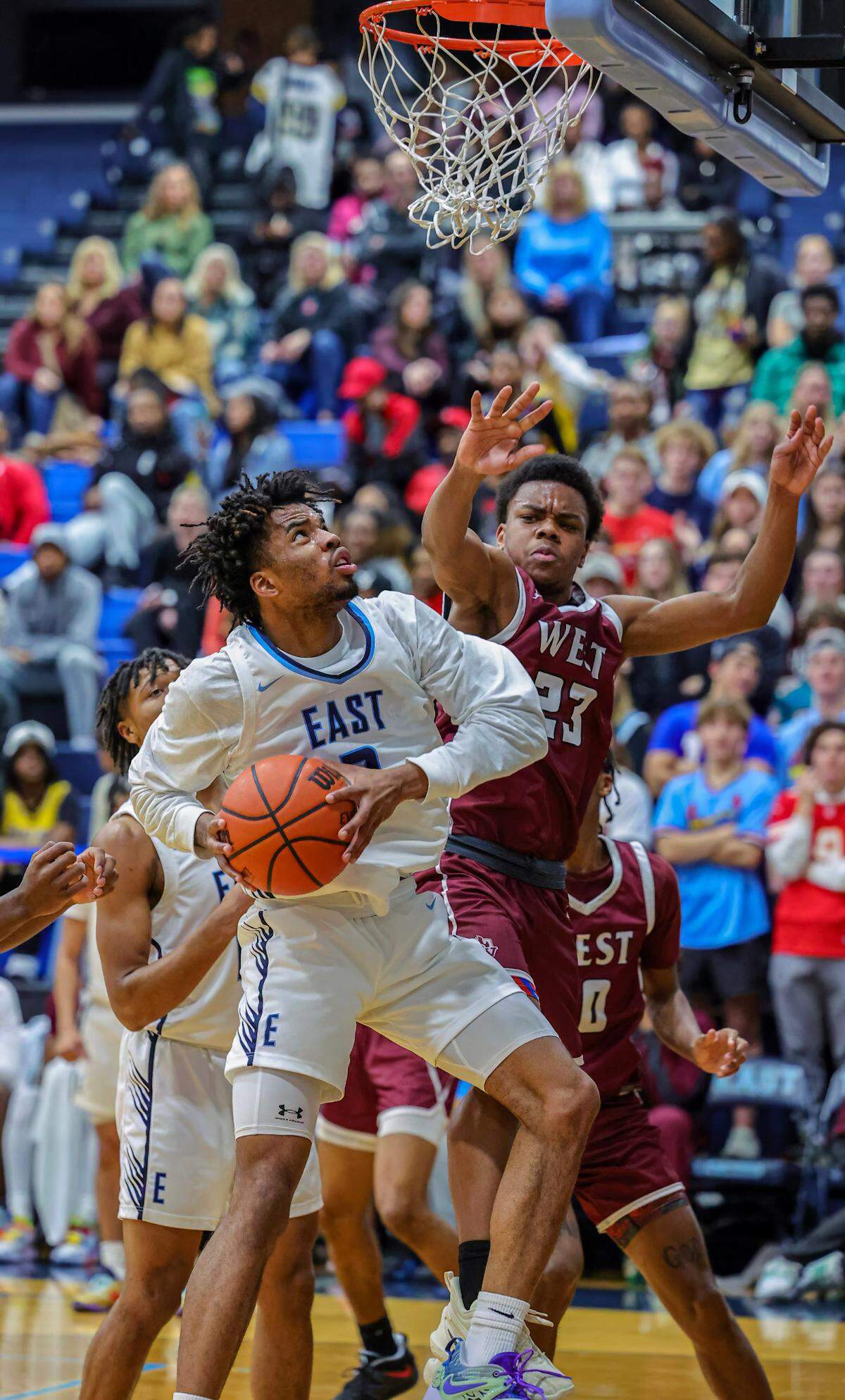 Belleville East’s Antwine Wilson goes to the basket against Belleville West’s Jordan Lacey during the Chick-fil-A Classic championship game. The Lancers ultimately prevailed 57-52.