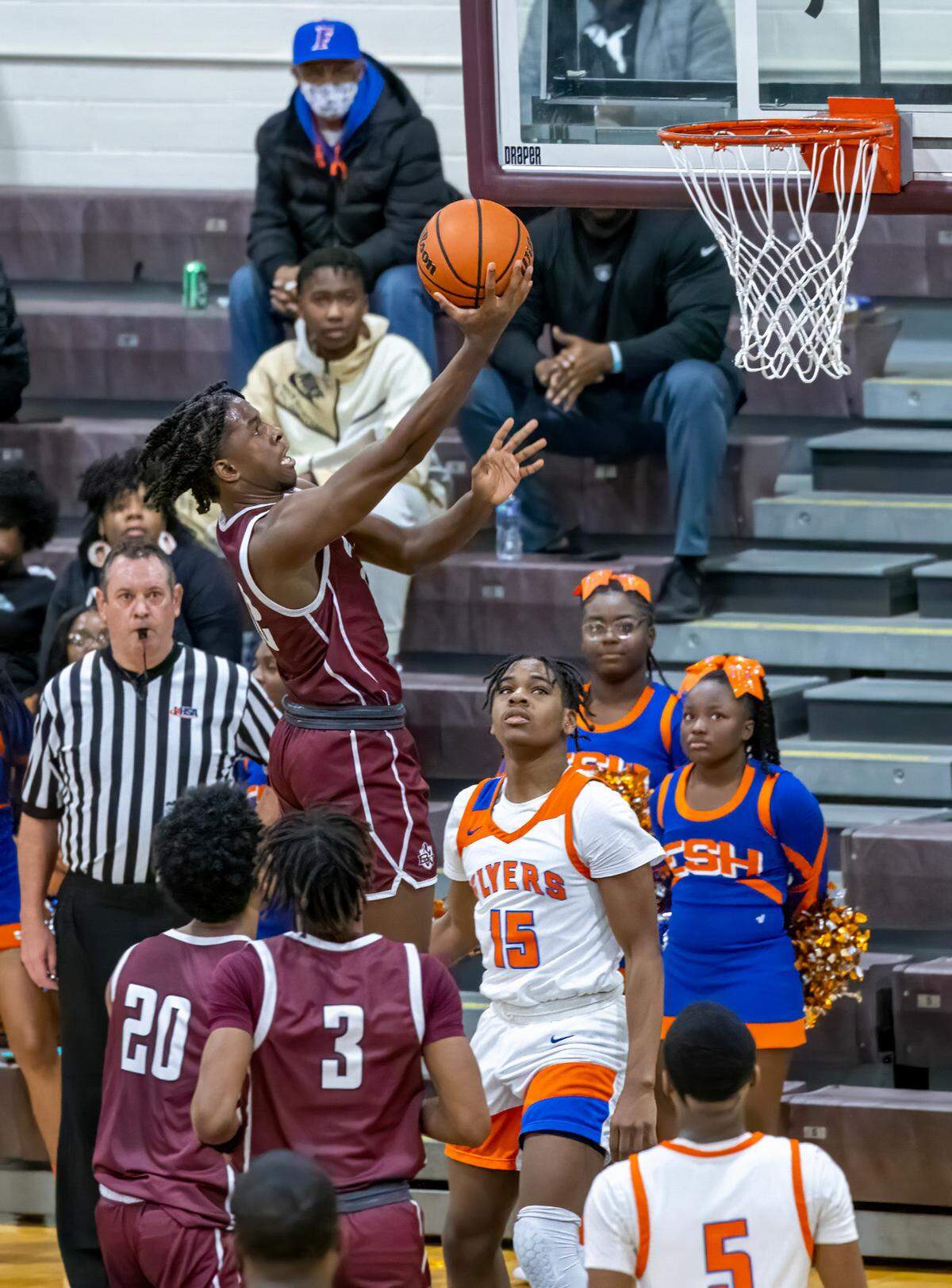 Belleville West’s Myles Liddell goes to the basket during Friday’s Southwestern Conference game against East St. Louis. The Maroons ultimately fell to the Flyers 81-52.