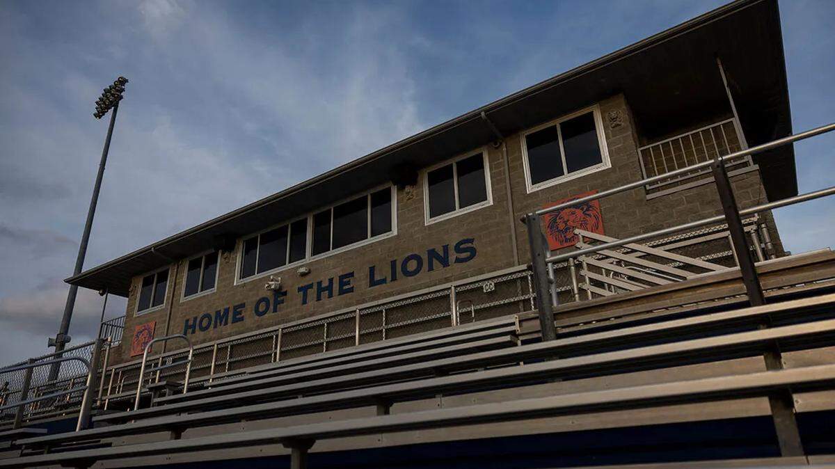 The sun sets on the press box at Lions Field football stadium at Carterville High School.
