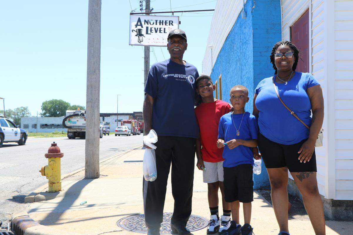 George Mays, left, poses with his family, Dakari Jefferies, Jevon Gibson and Jayla Lewis, as the Juneteenth motorcade passes through East St. Louis Saturday.